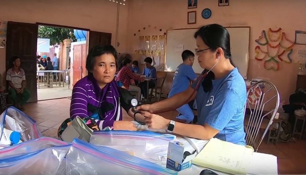 IHM medical volunteer performing a health checkup during a mission trip