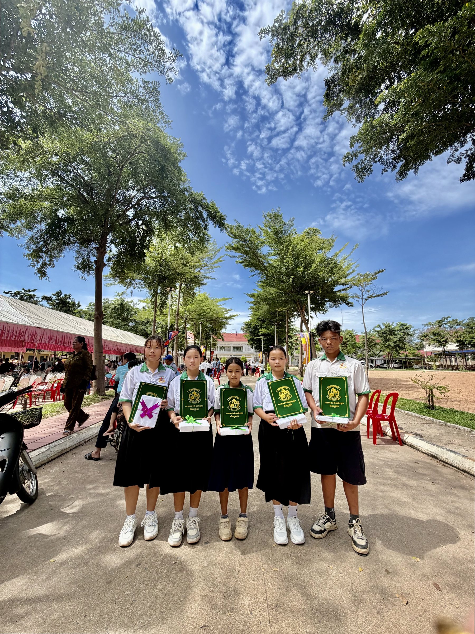 Five IHM students together after the awards ceremony, holding their certificates