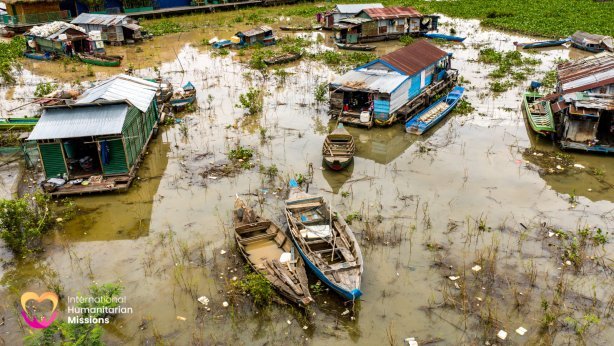 An aerial view of a flooded floating village in Tonle Sap, Cambodia — where families like Tao's live and struggle