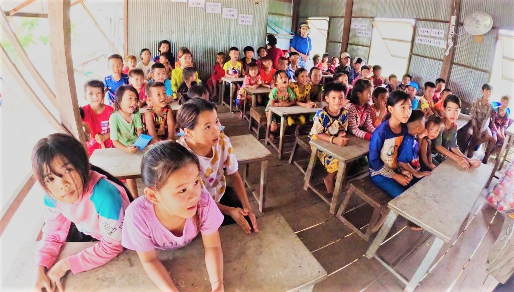 children in TonLe Sap wait patiently for their class to start