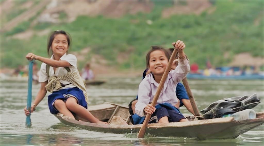 two girls row their boat going to school